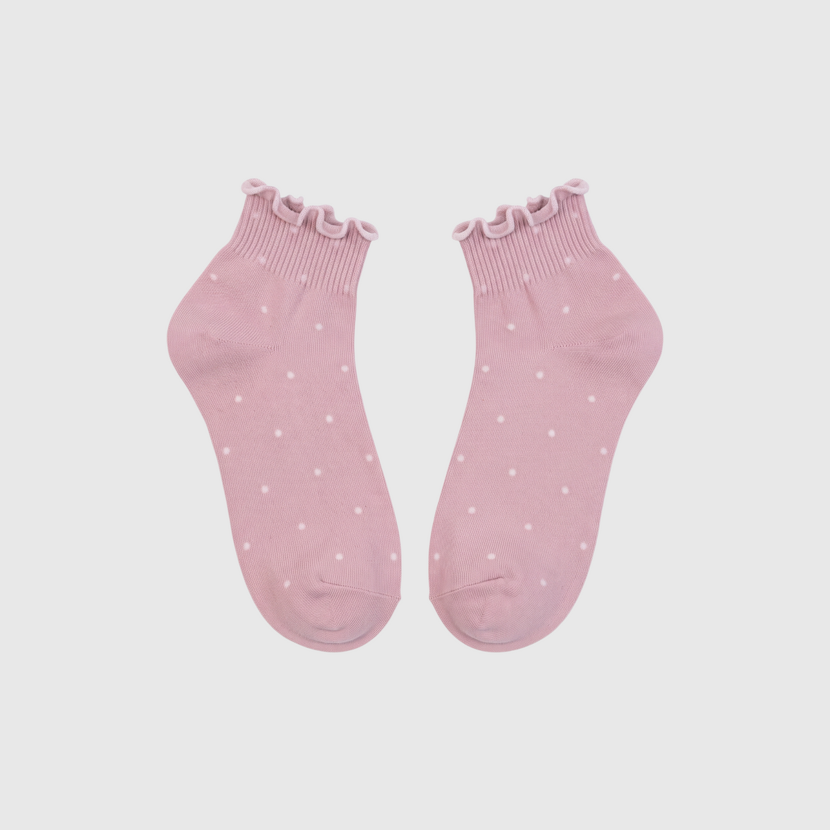 SUNMOOL baby pink ankle socks with white polka dots and ruffled lettuce-edge cuffs in a soft cotton blend.