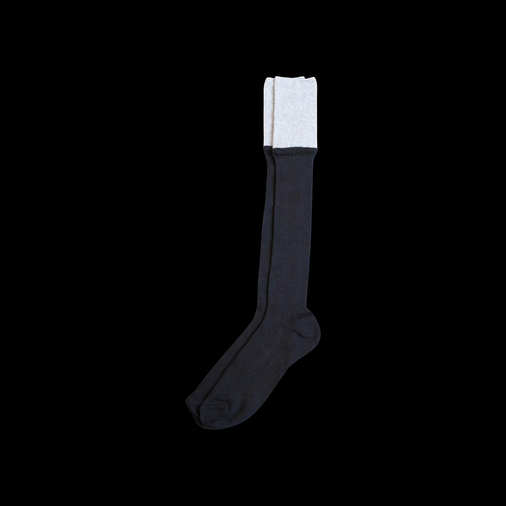 SUNMOOL black knee-high socks featuring a contrasting light grey dip-dyed cuff and a ribbed knit structure.