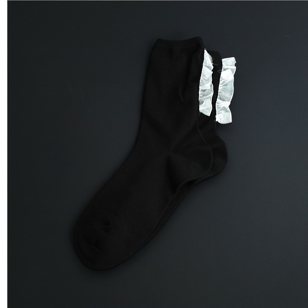 SUNMOOL black crew socks with delicate white ruffle trim detail.