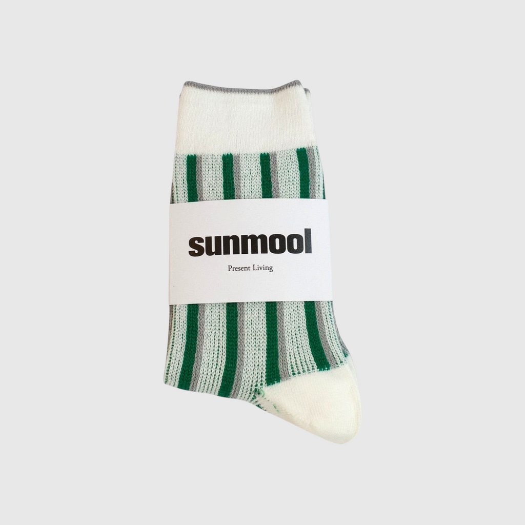 SUNMOOL dual stripe socks in ivory with green and grey vertical stripes, featuring a branded paper wrap.