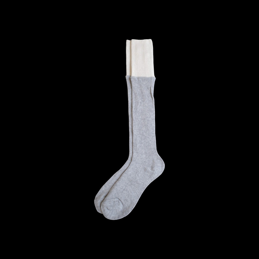 SUNMOOL grey knee-high socks with a contrasting white dip-dyed ribbed cuff on a black background
