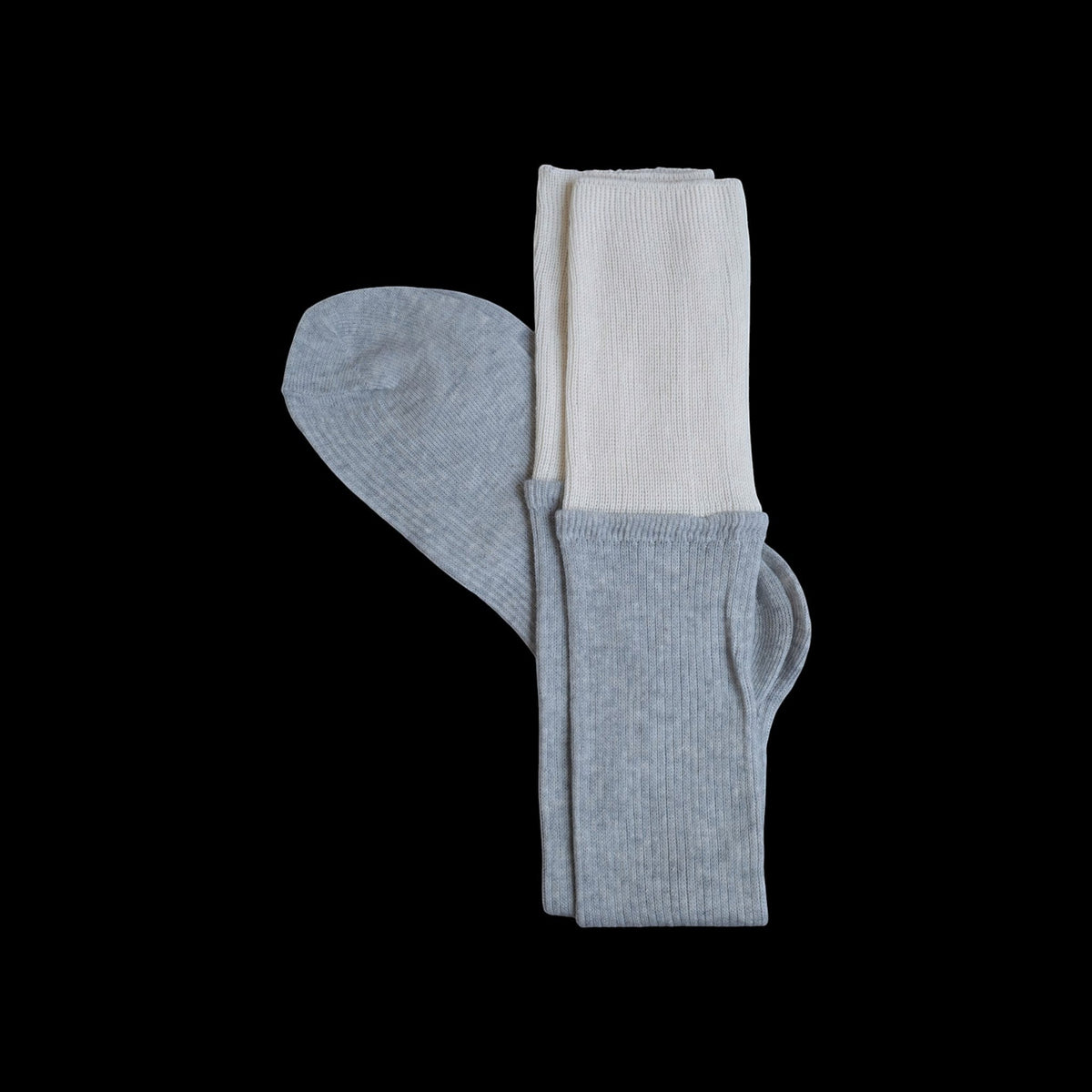 SUNMOOL grey knee-high socks with a contrasting cream dip-dyed ribbed cuff on a black background.