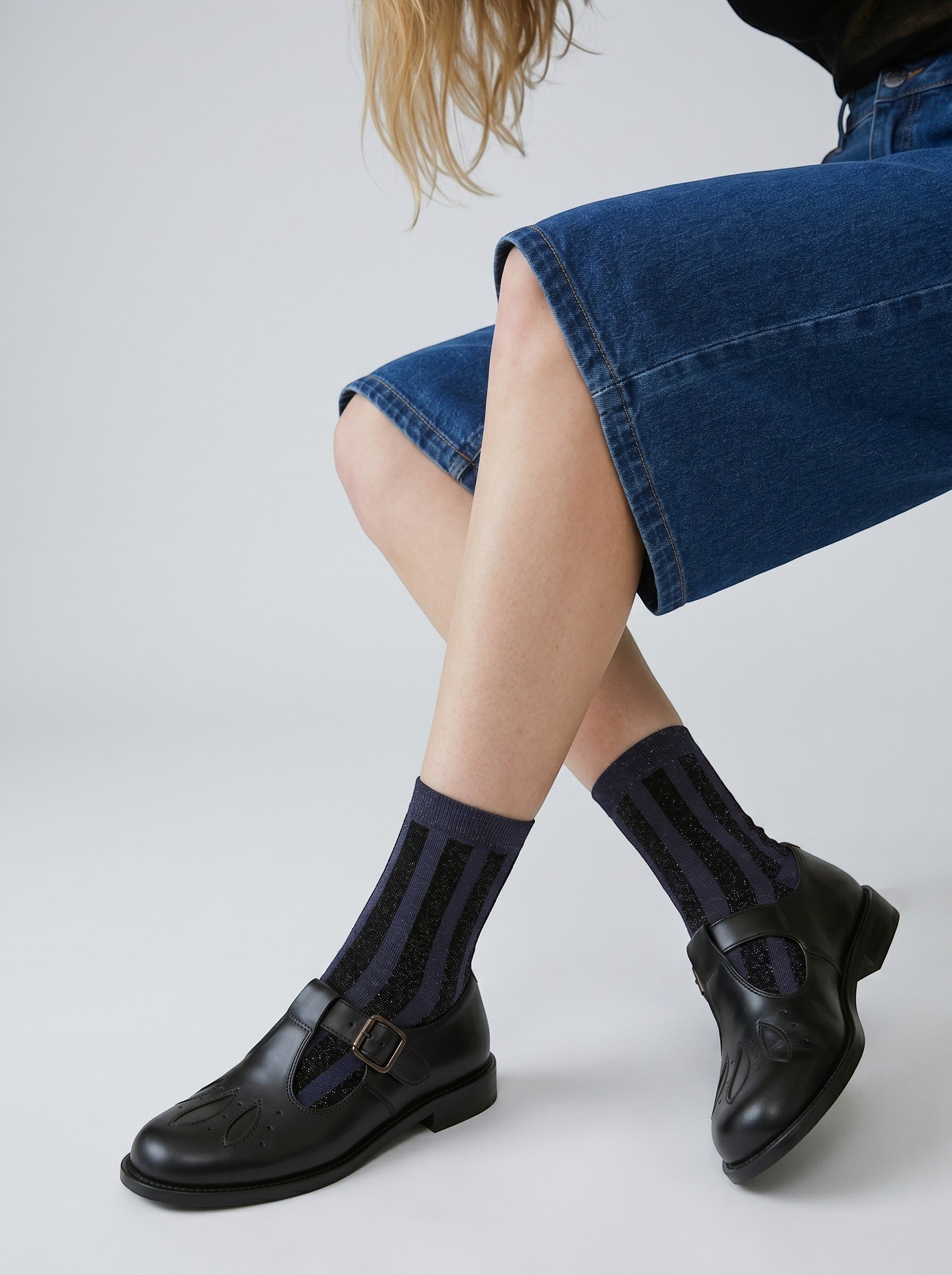 SUNMOOL grey striped socks with shimmering tinsel threading worn with black leather T-strap shoes and denim shorts.