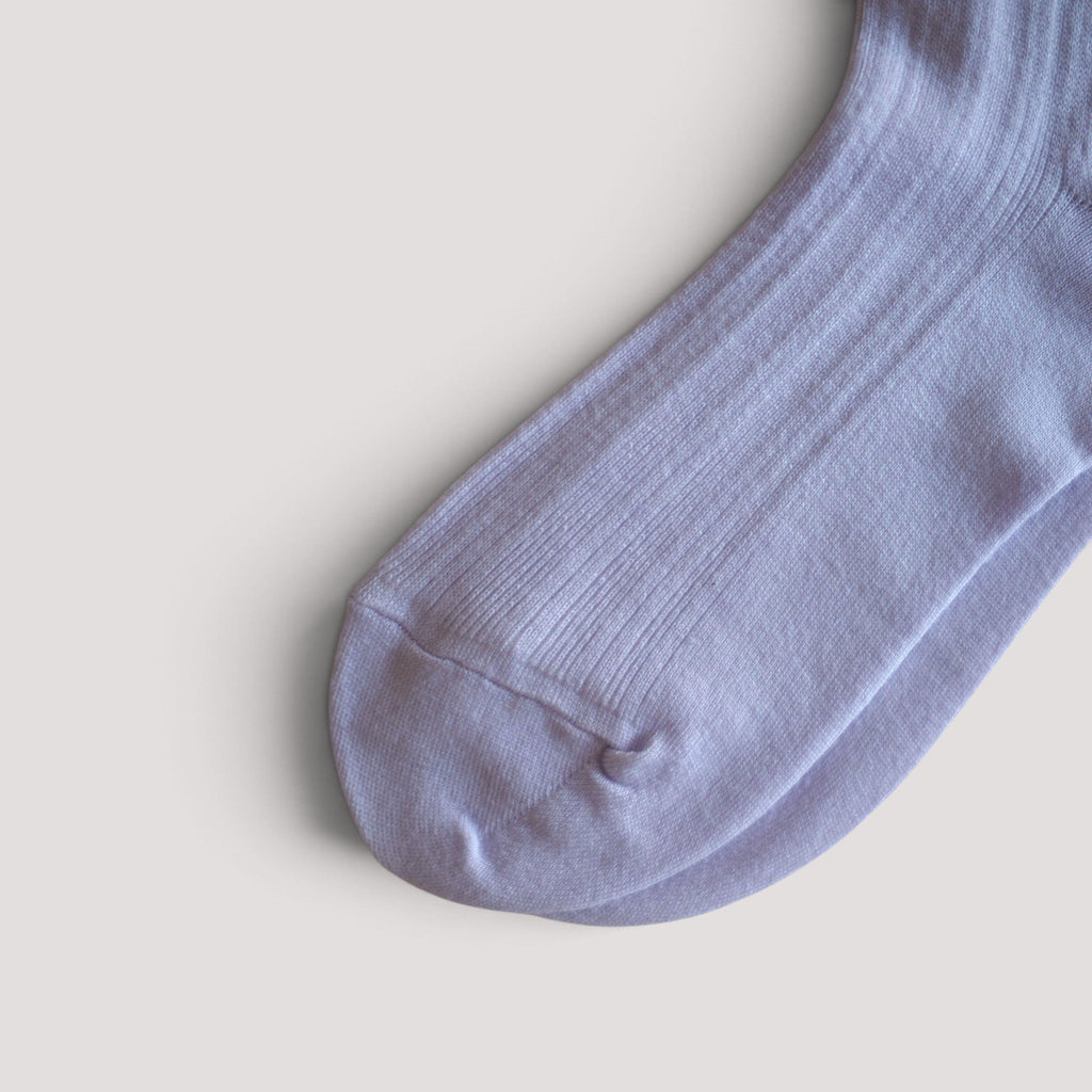 SUNMOOL Pastel Cloud socks in a soft lavender ribbed knit fabric, shown in a close-up view.
