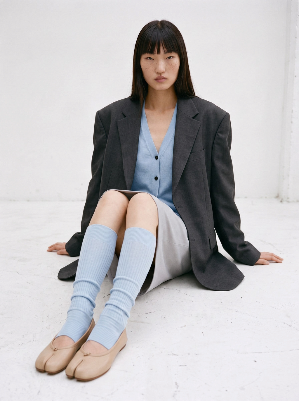 SUNMOOL light blue ribbed open-toe knee-high socks worn with beige tabi flats and a grey blazer outfit