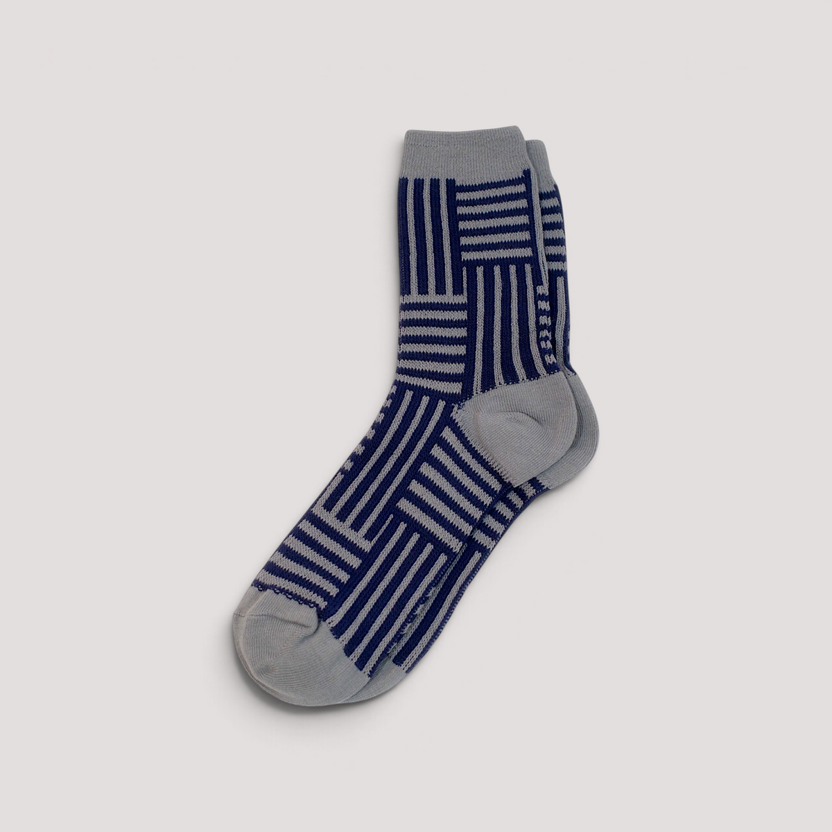 SUNMOOL crew socks featuring a navy blue and grey geometric line drawing pattern on a neutral background