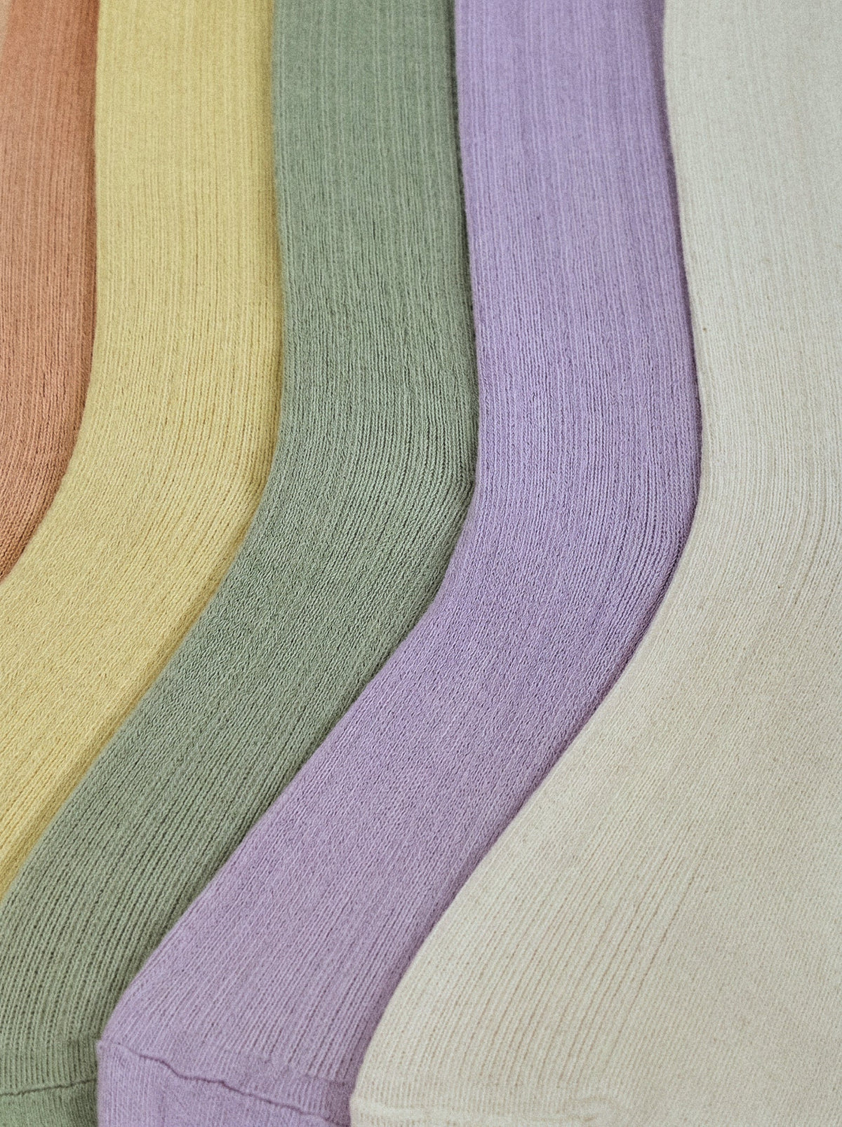 SUNMOOL Pastel Cloud socks in a set of soft ribbed cotton colors including plum, mustard, mint, lavender, and white.