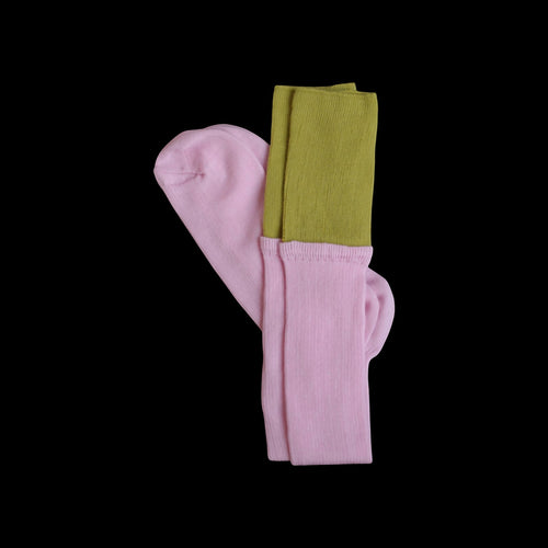 SUNMOOL knee-high socks in pink with a contrasting olive green dip-dyed ribbed cuff on a black background.
