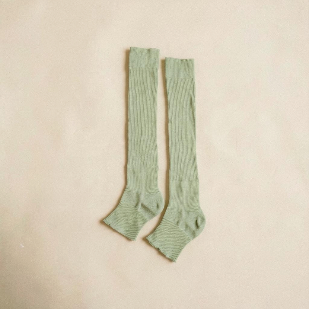 SUNMOOL sage green ribbed knee-high open-toe socks for ballet or casual wear on a neutral background