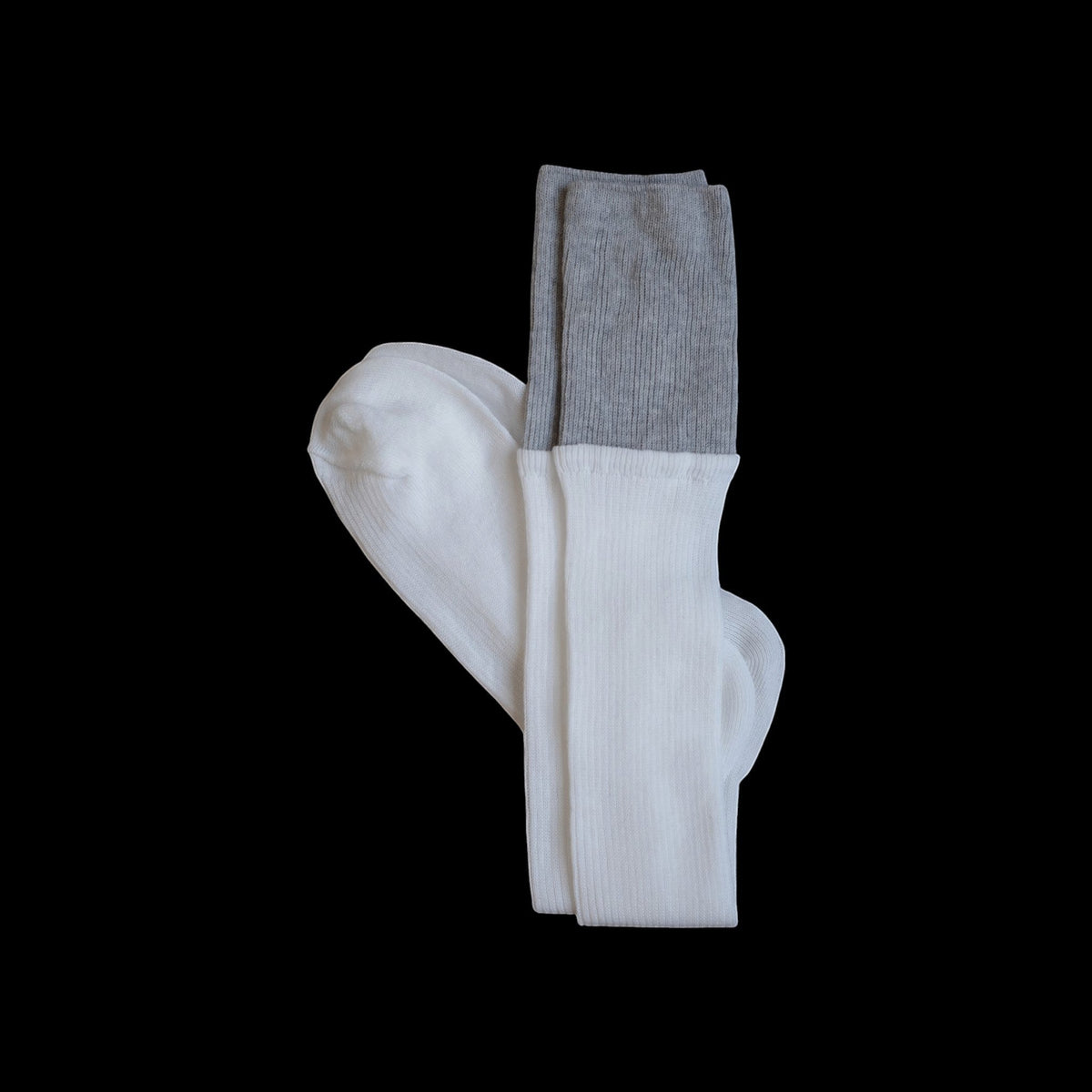 SUNMOOL white knee-high socks with a grey dip-dyed ribbed cuff, styled for an editorial look.