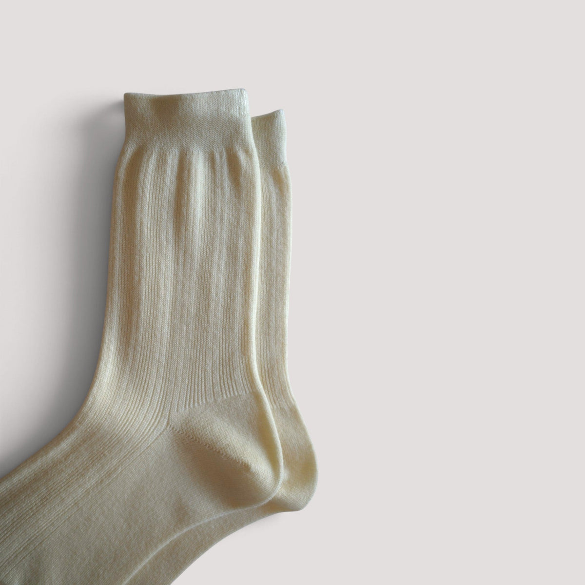 SUNMOOL Pastel Cloud socks in white, featuring a soft ribbed knit texture and comfortable crew length design.